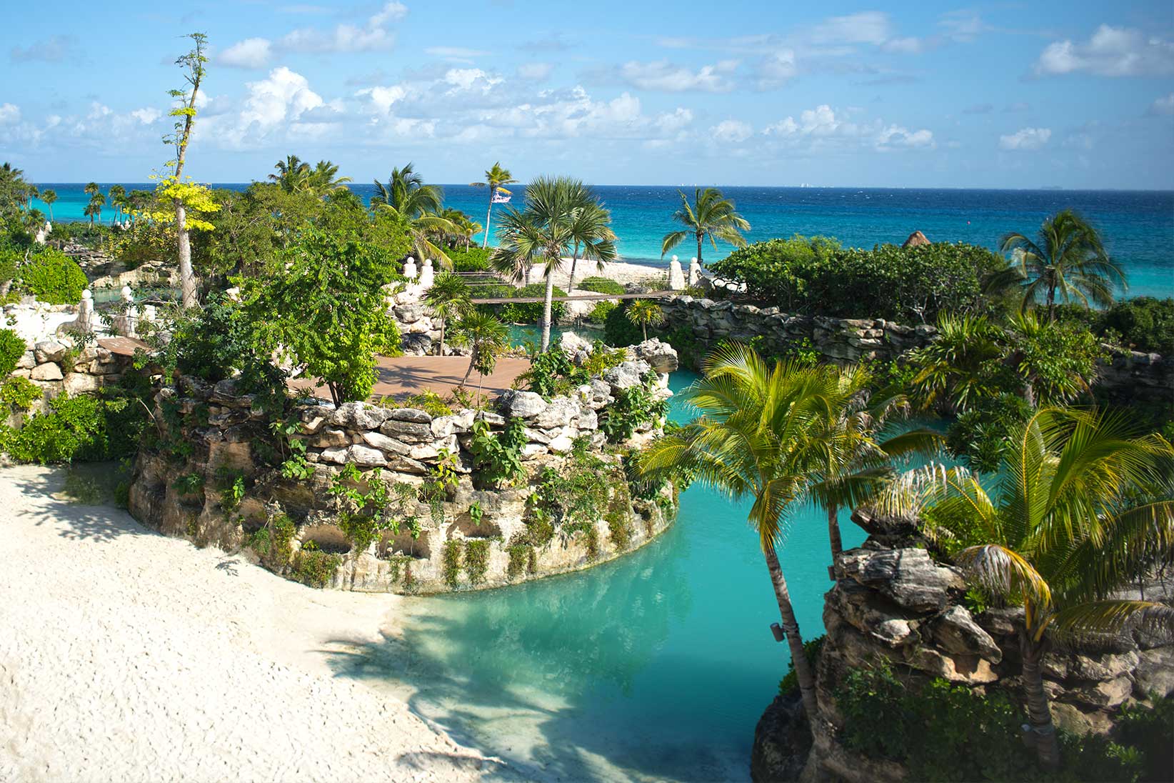 Warm Xcaret stone, water, and destination wedding setting.